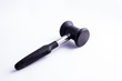 © laura - Meat mallet or tenderizer; black plastic and metal; issolated on white background