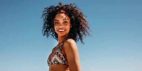 Portrait of a curly haired woman in bikini