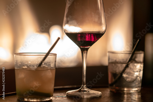 Close Up Of Glasses Of Vodka Rum And Red Whine Against Fire Pit