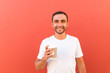 © F8  \ Suport Ukraine - Handsome cool man with coffee cup to go isolated on red background