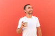 © F8  \ Suport Ukraine - Handsome cool man with coffee cup to go isolated on red background