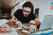 © VadimGuzhva - Portrait of Young Graphic Designer Works Indoors