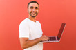 © F8  \ Suport Ukraine - Handsome programmer man with laptop on red background