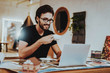 © VadimGuzhva - Smiling Young Graphic Designer Has Coffee Break
