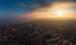 Aerial panorama of dramatic sunset above evening Voronezh city in haze or fog, bird eye view of urban downtown architecture in twilight