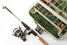 Box With Tackle And Fishing Rod On White Background