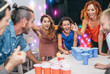 © Alessandro Biascioli - Group of happy friends playing beer pong in pub cocktail bar - Young millennials people having fun doing party alcohol games at night - Friendship and youth lifestyle nightlife concept