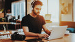 © VadimGuzhva - Stylish Guy in Headphones Use Laptop at Workplace