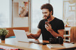 © VadimGuzhva - Nervous Guy Holds Phone Works on Laptop Remotely