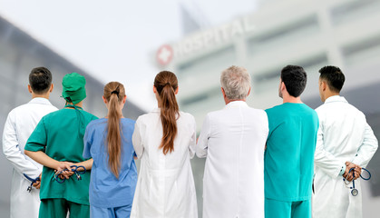 Wall Mural - Healthcare profession teamwork and doctor service concept - International medical staff group of doctors, nurses and surgeon specialist standing with stethoscopes in the hospital.