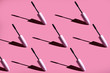 many mascara brushes on a pink background hard light