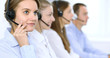 © rogerphoto - Call center operator in headset while consulting client. Telemarketing or phone sales