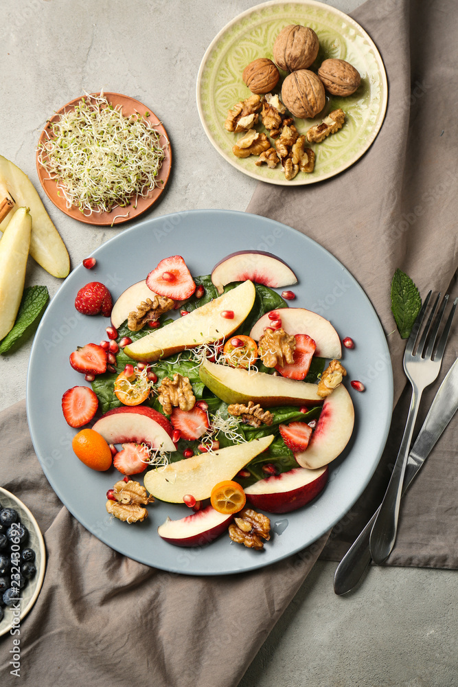 Delicious fresh salad with walnuts on plate
