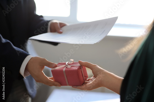 Cuadros en Lienzo Businessman taking bribe from woman. Corruption concept