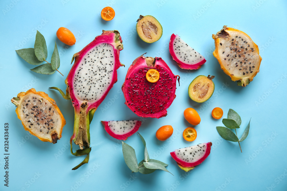 Tasty pitahaya and other fruits on color background