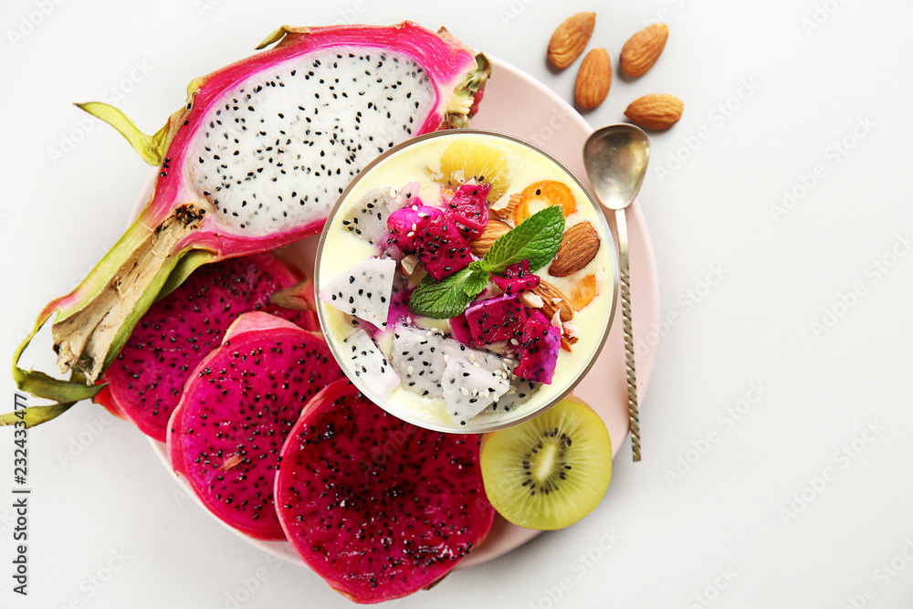 Yogurt with dragon fruit in bowl on light background