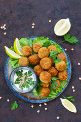 Canvas Print - Homemade falafel made from chickpeas, on salads. Dark background.