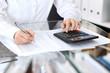 © rogerphoto - Bookkeeper woman or financial inspector  making report, calculating or checking balance, close-up. Business portrait. Copy space area for audit or tax concepts