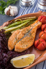 Wall Mural - Grilled salmon fillets  with baked vegetables on a plate. Closeup