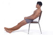 © Curto - Young man naked and relaxed  sitting on a chair