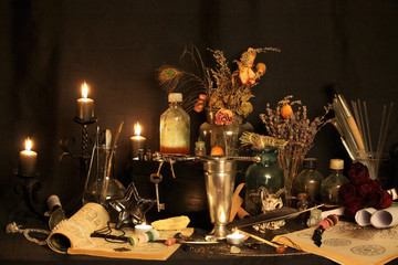 Antique Magic Book. Witchcraft Peacock feathers and candle background. Black candle Magic Ritual.