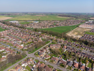 Typical UK Town aerial photo showing rows of houses, roads, parks and communal area