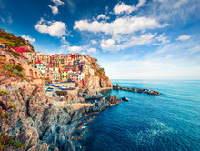 Second city of the Cique Terre sequence of hill cities - Manarola. Colorful spring morning in Liguria, Italy, Europe. Picturesqie seascape of Mediterranean sea. Traveling concept background.