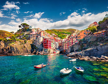 First City Of The Cique Terre Sequence Of Hill Cities - Riomaggiore. Colorful Morning View Of Liguria, Italy, Europe. Great Spring Seascape Of Mediterranean Sea. Traveling Concept Background.