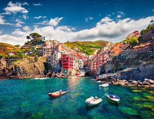 Wall Mural - First city of the Cique Terre sequence of hill cities - Riomaggiore. Colorful morning view of Liguria, Italy, Europe. Great spring seascape of Mediterranean sea. Traveling concept background.