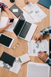 © LIGHTFIELD STUDIOS - cropped shot of businesspeople working at workplace with digital devices and documents