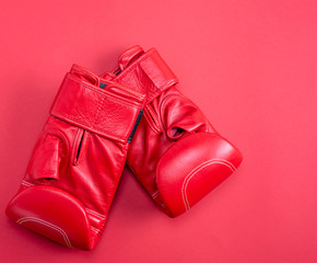 red sport leather boxing gloves on a red background