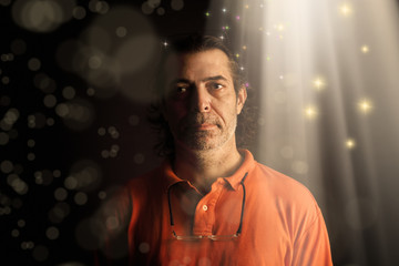 Wall Mural - Conceptual portrait of adult man with beam of light and abstract light manipulation.