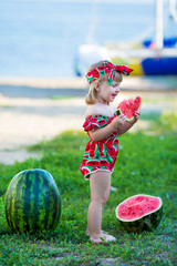 Wall Mural - Happy child on the sea tropical beach with watermelon in hands enjoy life time weekend wearing fancy stylish retro swim wear bikini and bandana with yacht on background