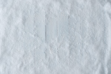 Poster - White wooden table background with snow. Winter or Christmas top view. Minimal flat lay.