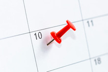 Close Up 10 Date Pinning On Calendar With Red Color Pin Thumbtack. Save The Date Concept.