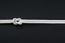 White Ship Ropes Connected By Reef Knot On Black