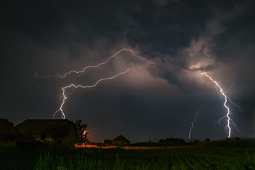 Wall Mural - several lightningbolts strike out of a severe thunderstorm