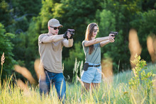 The Instructor Teaches The Girl To Shoot A Pistol At The Range
