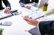 © ordinary042 - businessman discussing with financial documents together in meeting room.