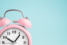 Pink Alarm Clock On Blue Background
