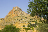Fototapeta Paryż - The rock face of mount Arbel in the Valley of The Doves in Israel