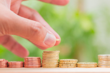 coins stacks on wooden table isolated blur green nature background