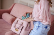 © cherry_d - Beautiful young blonde woman with light pink handbag and mobile phone. Portrait of pretty blonde girl in pink clothes.