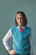 © Stocksy - gender neutral tween girl in sweater, shirt and tie