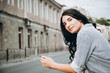 © ryzhenko23 - beautiful woman standing by rail at the street and looking at camera. portrait