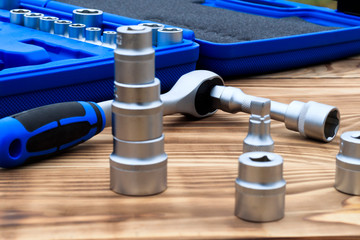 set of heads for car repairs. ratchet on a wooden blue background. ratchet close-up