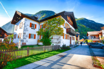 Scenic view of famous Hallstatt viilage. Typical Austrian Alpine houses with bright flowers