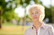 © Maria Sbytova - Outdoors portrait of beautiful smiling senior woman with curly white hair