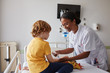 © Stocksy - Doctor female giving attention and care to child in a hospital room