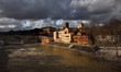 Winter in Rome. River is swollen along Tiber Island embankments under stormy clouds